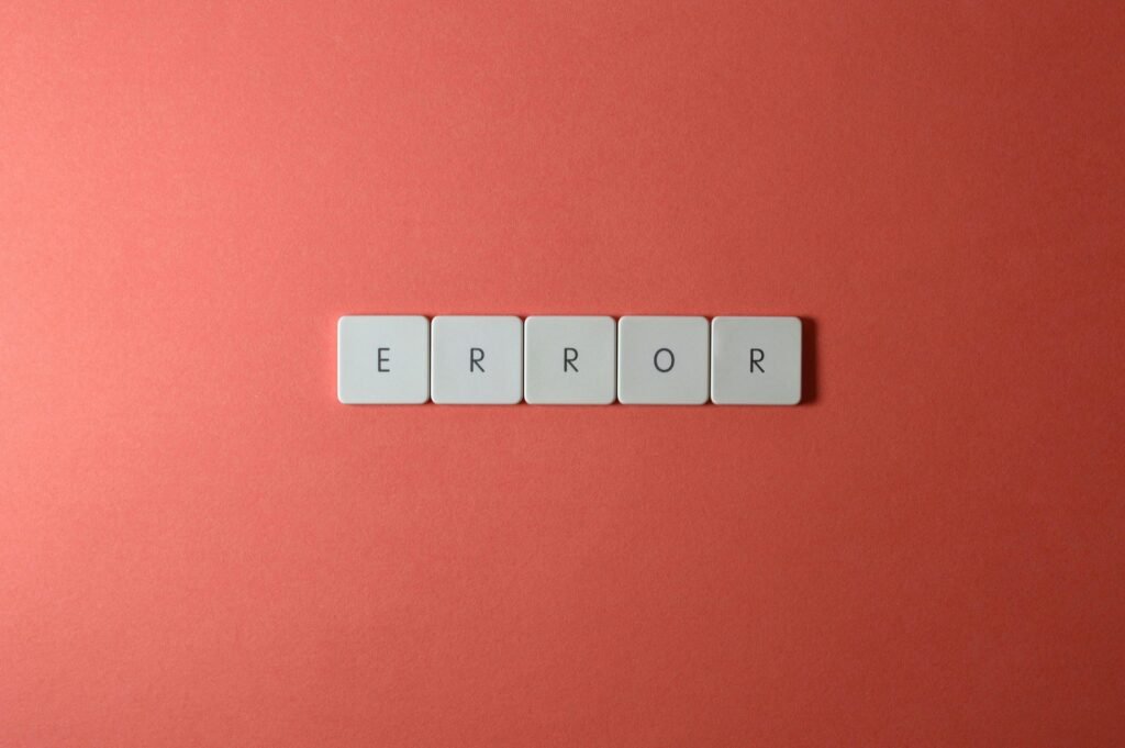 White letter tiles spelling 'ERROR' on a red backdrop, offering a minimalist design concept.
